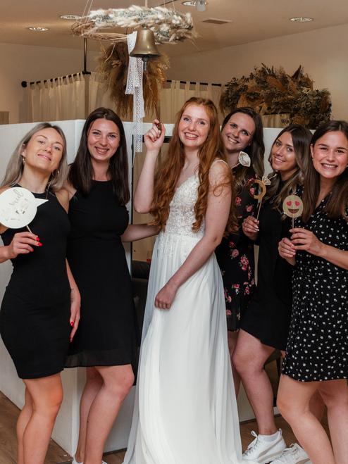 Erfolgreicher Anprobetermin Brautladen Braut in der Mitte ihrer Freundinnen